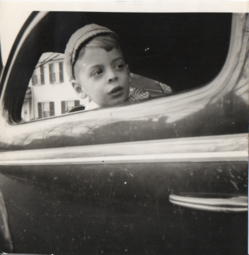 my father as a child, looking out a car window.